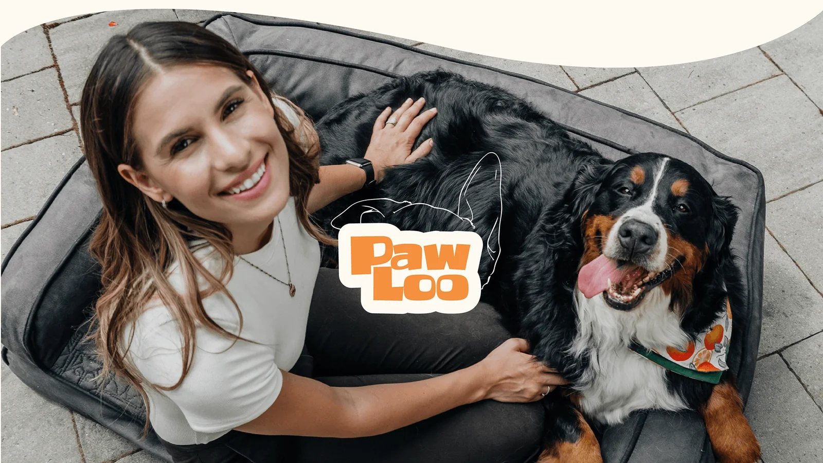 A woman and her Bernese mountain dog on a dog bed, with the PawLoo logo.