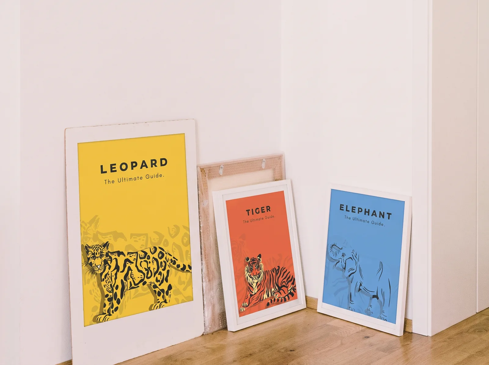Leopard, tiger and elephant posters leaning against a wall